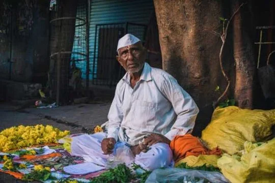 vendor selling flowers posing