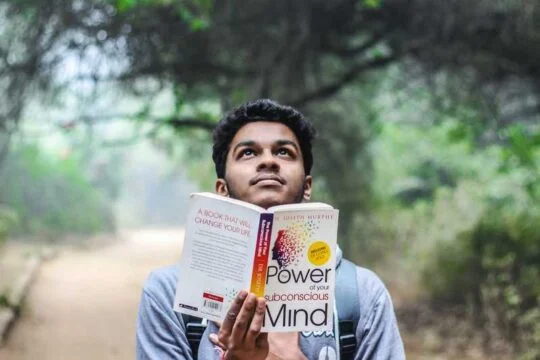 natural pose of boy holding book